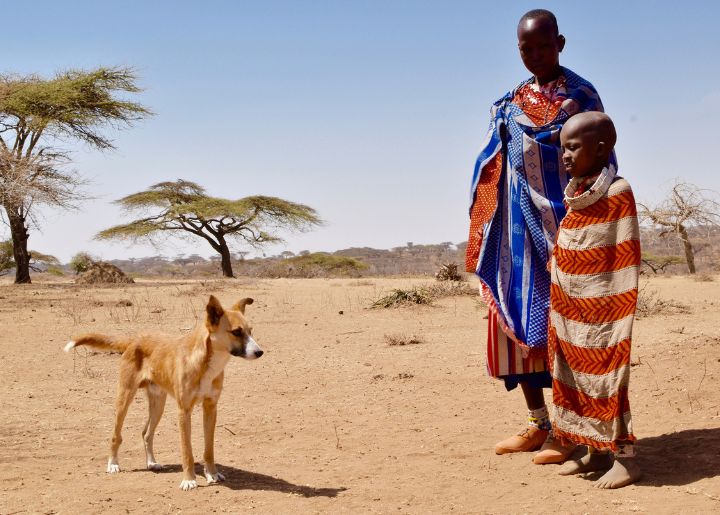 Woman and child standing near dog