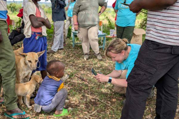 Vetcor Vet taking photo of child with dogs